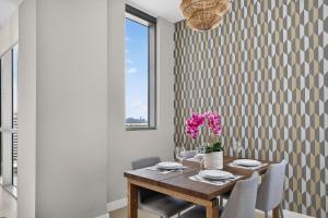 a dining room with a wooden table and chairs at Ocean 2 Sky at Monte Carlo Miami Beach in Miami Beach