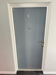 a blue door with a silver handle in a room at Ogle Street 1-Bed Apartment in Armagh