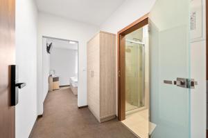 a bathroom with a toilet and a glass door at Apartmány Star Lipno - Self Check-in in Lipno nad Vltavou +149 photos