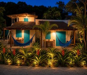 a house with a hammock in front of it at Viva Vida Caraiva in Caraíva