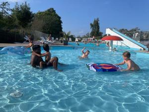 a group of children playing in a swimming pool at Feriepark Langeland Ristinge (Feriepark Langeland) in Humble