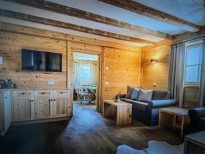 a living room with a couch and a tv at Casa Belluno in Belluno