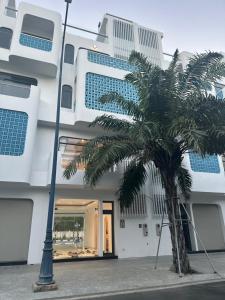 a palm tree in front of a building at Aviera Boutique in Liên Trì (4)