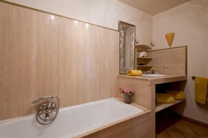 a bathroom with a bath tub and a sink at Le Maria Venezia in LʼÎle-Rousse +15 photos