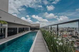 a swimming pool on the roof of a building at Actual House in Uberlândia