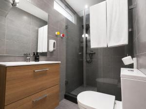 a bathroom with a toilet and a shower and a sink at RENT-INN Suites Hotel in Rabat +42 photos