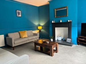 a living room with a couch and a fireplace at Delightful Durham Home in Gilesgate