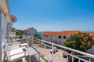 a balcony with a bench and some buildings at Apartments Joy in Cavtat
