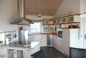 a kitchen with white cabinets and white appliances at Outstanding Close To Nice Beachh in Karrebæksminde