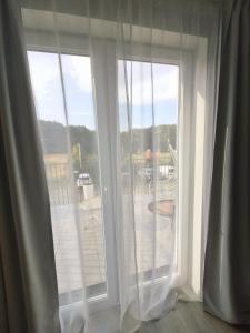 an open window with a view of a deck at Ludna 27 in Niechorze