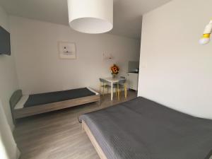 a room with two beds and a table in it at Ludna 27 in Niechorze