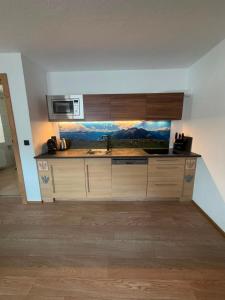 a kitchen with a sink and a microwave at Peatr Seppa Hof in Nauders +8 photos