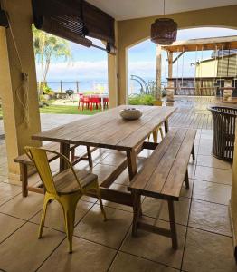 a wooden table and chairs on a patio at Villa Ö Schandél in Saint-Paul