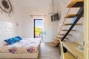 a bedroom with a bed and a staircase at Baja Azzurra in Bari Sardo +117 photos