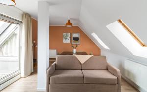 a living room with a chair and a table at Limehome Chemnitz Hartmannstraße in Chemnitz