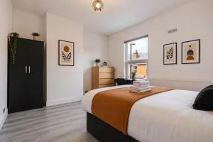 a bedroom with a large bed and a window at Coventry Contractor Hub - 4-Bedroom House with Free Parking-CV5 in Spon End +24 photos
