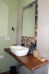 a bathroom with a sink and a mirror at B&b Red House in Garlate