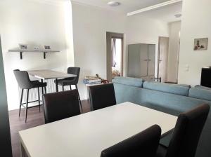 a living room with a blue couch and a table at Parkside Home in Törökbálint