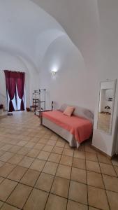 a bedroom with a bed and a tiled floor at Dimora Suriano in Altamura