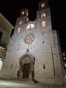 a building with a clock tower at night at Dimora Suriano in Altamura