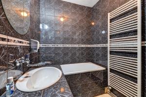a bathroom with a sink and a mirror at Holiday houses BARCA in Košice +17 photos