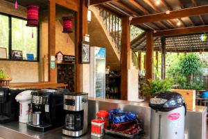 a coffee shop with coffee machines on a counter at Maewin Resort in Ban Huai Rin +58 photos