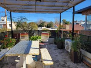 a patio with two chairs and a table and chairs at Lucipri CyN in Arroyito