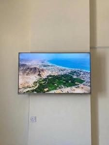 a flat screen tv hanging on a wall at Aknan Center Market in Salalah