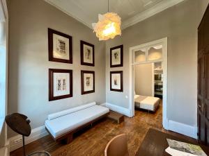 a living room with a couch and a chandelier at Thirty8 Heritage House in Chania