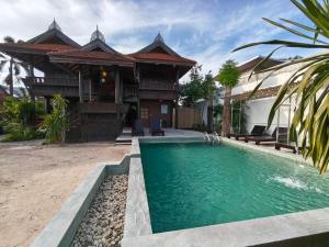 a house with a swimming pool in front of it at Fueangfu Pool Villa Chaweng in Chaweng