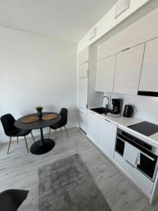 a kitchen with a table and chairs in a room at Convenient Studio for 2 in Nokia