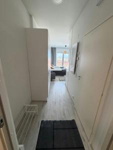 an empty hallway with a room with a couch at Convenient Studio for 2 in Nokia