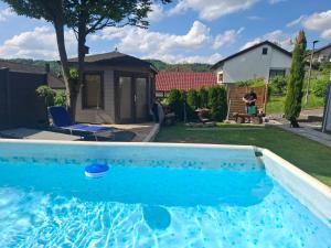 a swimming pool in the backyard of a house at Dörrs vacation home with heated pool and garden in Weißbach