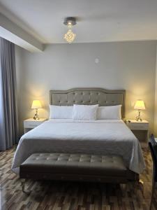 a bedroom with a large bed with two night stands at Terraza Apart Hotel in Pichanaki +28 photos
