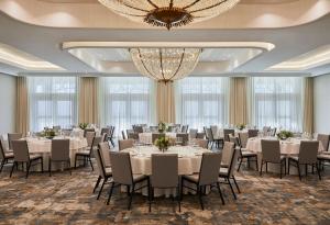 a ballroom with tables and chairs and a chandelier at InterContinental Table Bay Cape Town by IHG in Cape Town +126 photos