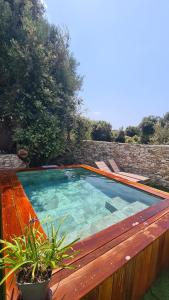 a large swimming pool sitting on top of a wooden deck at Perla Di Macchia in Bonifacio +81 photos