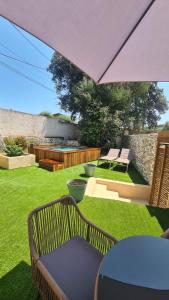 a patio with a table and chairs and an umbrella at Perla Di Macchia in Bonifacio