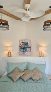 a bed with two pillows on top of it at Perla Di Macchia in Bonifacio