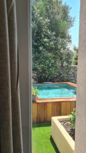 a view of a swimming pool from a window at Perla Di Macchia in Bonifacio