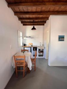 a kitchen and dining room with a table and chairs at KOLOMBA GUESTS House in Vrachonisída Skylonísi +34 photos