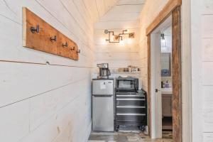 a kitchen with a refrigerator and a stove in a room at The Evergreen | Walk to Rangeley Lake, Sled & ATV Access in Rangeley