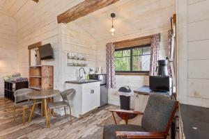 a kitchen with a table and chairs in a room at The Alpine Suite | Walk to Downtown & Rangeley Lake Beach in Rangeley