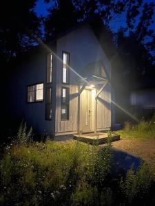 a small house with a door in the yard at The Alpine Suite | Walk to Downtown & Rangeley Lake Beach in Rangeley