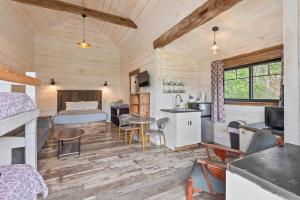 a bedroom and living room with a bed and a kitchen at The Alpine Suite | Walk to Downtown & Rangeley Lake Beach in Rangeley