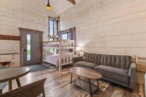 a living room with a couch and a bunk bed at The Alpine Suite | Walk to Downtown & Rangeley Lake Beach in Rangeley +18 photos
