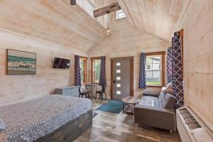 a bedroom with a bed and a couch in a room at The Summit Suite | Walk to Rangeley Lake • ATV & Sled Access in Rangeley