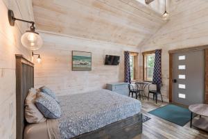 a bedroom with a bed and a table and chairs at The Summit Suite | Walk to Rangeley Lake • ATV & Sled Access in Rangeley +15 photos