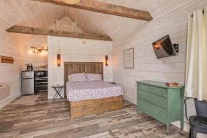 a bedroom with a bed and a green dresser at The Lupine | Cross Stone Cabins • Walk to Rangeley Lake in Rangeley