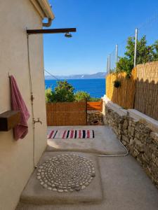 a door to a house with a view of the ocean at Porto Vigla in Tranakatika