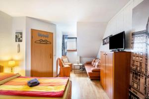 a bedroom with a bed and a living room at Reihenhaus Römmer in Altenstadt